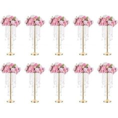 twelve pink flowers are arranged on gold poles