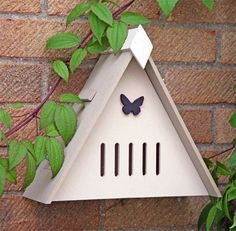 a white birdhouse with a butterfly on it