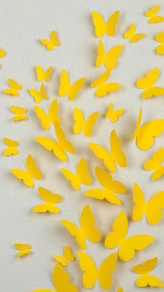 a bunch of yellow butterflies flying in the air