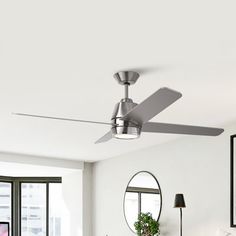 a living room with a couch, table and ceiling fan in the middle of it