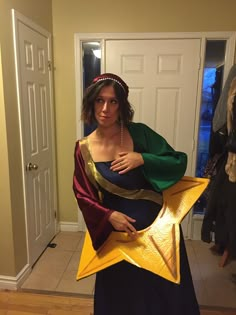 a woman dressed in costume holding a star