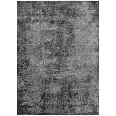 an old black and white rug with faded paint on the edges, it is very dark