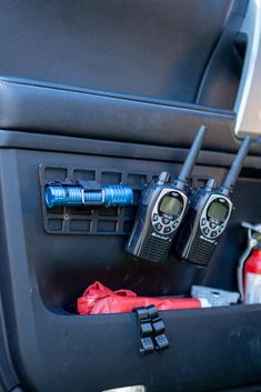 two walkie talkies sitting in the back seat of a car