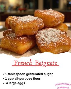 there are four sugar coated doughnuts on the plate and one is labeled french beginner's