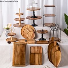 a table topped with lots of wooden plates and trays