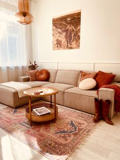 a living room with a couch, coffee table and rug