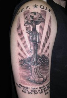 a man with a tattoo on his arm that has an image of a soldier's helmet and boot