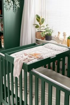 a baby crib with a blanket on top of it