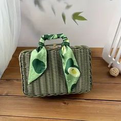 a green and white purse sitting on top of a wooden floor next to a radiator