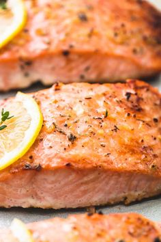 salmon with lemon slices and herbs on it