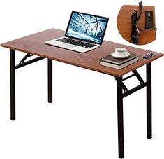 a laptop computer sitting on top of a wooden table next to a phone charger