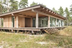 a small wooden cabin sitting on top of a lush green field