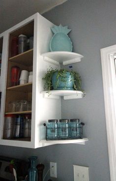 the shelves in the kitchen are filled with pots and pans on top of them