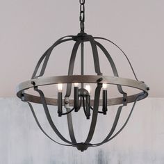 a chandelier with three lights hanging from it's center, in an industrial style