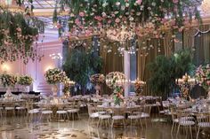 an elegant ballroom with floral arrangements and chandeliers