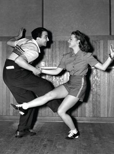 a man and woman dancing in front of a sign that says take more chance, dance more dances