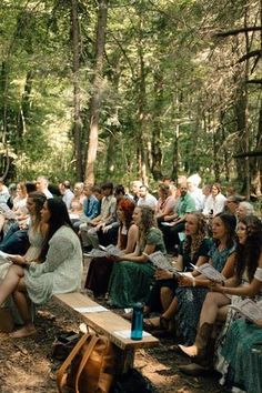 a group of people sitting in the woods