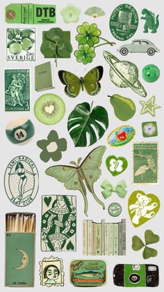 various green stickers are arranged on a white surface, including clovers and other items