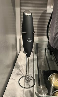 an electric hand blender sitting on top of a counter