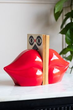 Book ends shaped like red lips. Lip Book, Childrens Bedroom Wallpaper, Kiss Goodbye, Kitchen Accessories Storage, Rockett St George, Mirrored Wall, Tin Ceiling Tiles, Bold Red Lips, Congratulations Gift