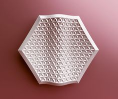 a white geometric object on a pink background