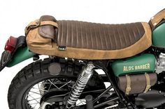 a green and brown motorcycle parked on top of a white background