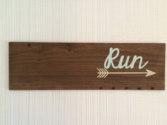 a wooden sign that says run with an arrow