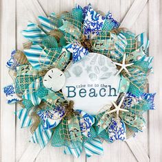 a wreath that says take me to the beach with sea shells and starfish on it