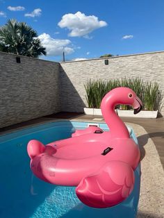 an inflatable pink flamingo sitting on top of a pool