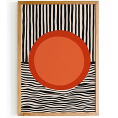 an orange plate sitting on top of a black and white striped wall