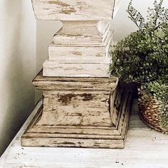 an old wooden box sitting next to a potted plant