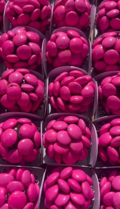 many pink candies are in plastic containers