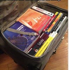 an open suitcase filled with books and other items