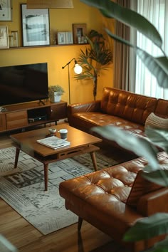 a living room filled with furniture and a flat screen tv on top of a wooden table