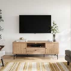 a flat screen tv mounted to the side of a wooden cabinet in a living room