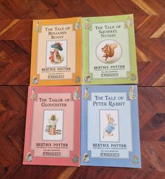 four children's books sitting on top of a wooden floor