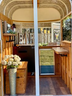 the inside of a trailer with flowers in it