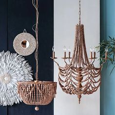 an assortment of chandeliers hanging from the ceiling in a room with blue walls