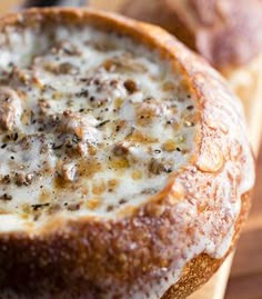 a close up of a bread bowl filled with food