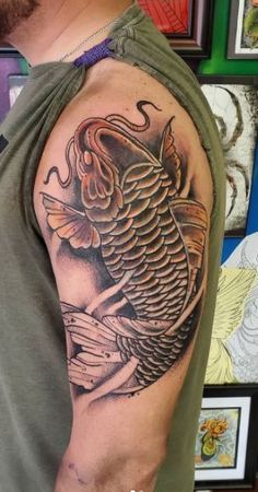 a man with a bird tattoo on his arm