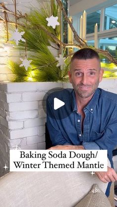 a man sitting in front of a fireplace with the words baking soda dough / winter themed mantle