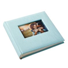 a blue photo album with an image of two women hugging each other on the cover