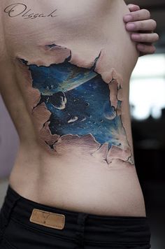 a woman's stomach with a piece of artwork on it that looks like the earth