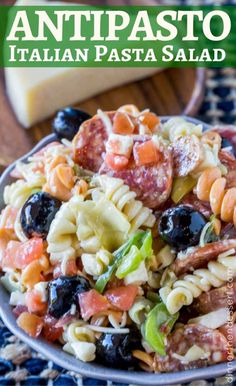 a pasta salad with olives, tomatoes, and cheese