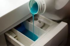 blue liquid pouring out of a container into a drawer