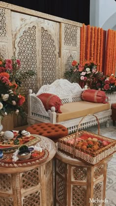 two small tables with baskets on them in front of an orange and white stage backdrop