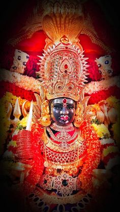 an idol is shown in the dark with red and yellow lights on it's face