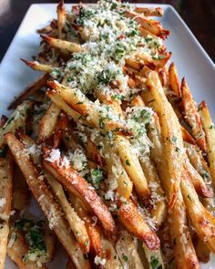 french fries with parmesan cheese and herbs on top