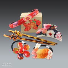 Love Japanese Style Like We Do This listing is for a set of  Japanese hair accessories. There is a brightly colored red and pink, floral chirimen fabric headband. There are two hair ties. One is a cute rabbit and the other a pretty flower. Both are made of a plastic covered floral chirimen fabric. There are two brown plastic tortoise shell kanzashi with an interesting knot accent and a plastic covered purple, pink and blue floral chirimen fabric hair clip.  These brightly colored hair accessorie Japanese Hair Piece, Japanese Hair Accessories, Fabric Hair Accessories, Japanese Kimono Accessories, Flower Hair Tie, Japanese Hair Clips Accessories, Kimono Accessories Japanese Hair, Geisha Hair Ornaments, Love Japanese