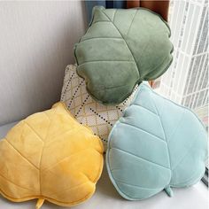 three pillows sitting next to each other on a couch